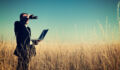 Businessman looking field for investment.