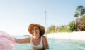 Photo of a young woman enjoying her vacation and cooling of on a hot summer day in a swimming pool