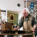 Exam enhancements detailed by FINRA Carpentry workshop where old antique furniture is professionally restored