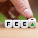Symbol for increasing or decreasing fees. Hand turns a dice and changes the direction of an arrow. Dice form the word "FEE".