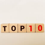 Top 10 sign made of wooden dices on a table i a bright environment with blue colors