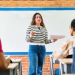 Former CCO blames poor legal advice for case Latin American college student making a presentation to her peers in class - education concepts