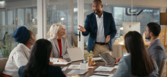 Meeting, speaker and team with business man in office for consulting, broker firm or discussion. Account manager, investor presentation and collaboration with employees in agency for portfolio review