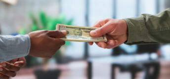 Young Man Gives Cash Payment To Delivery Courier For Quick Service.
