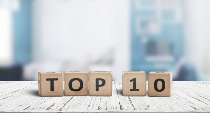 Top 10 sign made of wooden dices on a table i a bright environment with blue colors