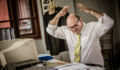 Overworked businessman having problems at work.