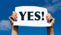 positive changes in the life, hands holding white sign on the sky background