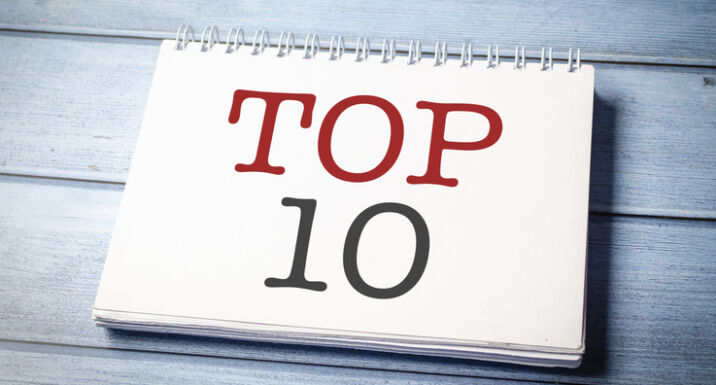 Top 10 sign on the white notepad on the blue wooden desk