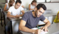 The SEC Exam Handbook Good-looking male student writing an exam